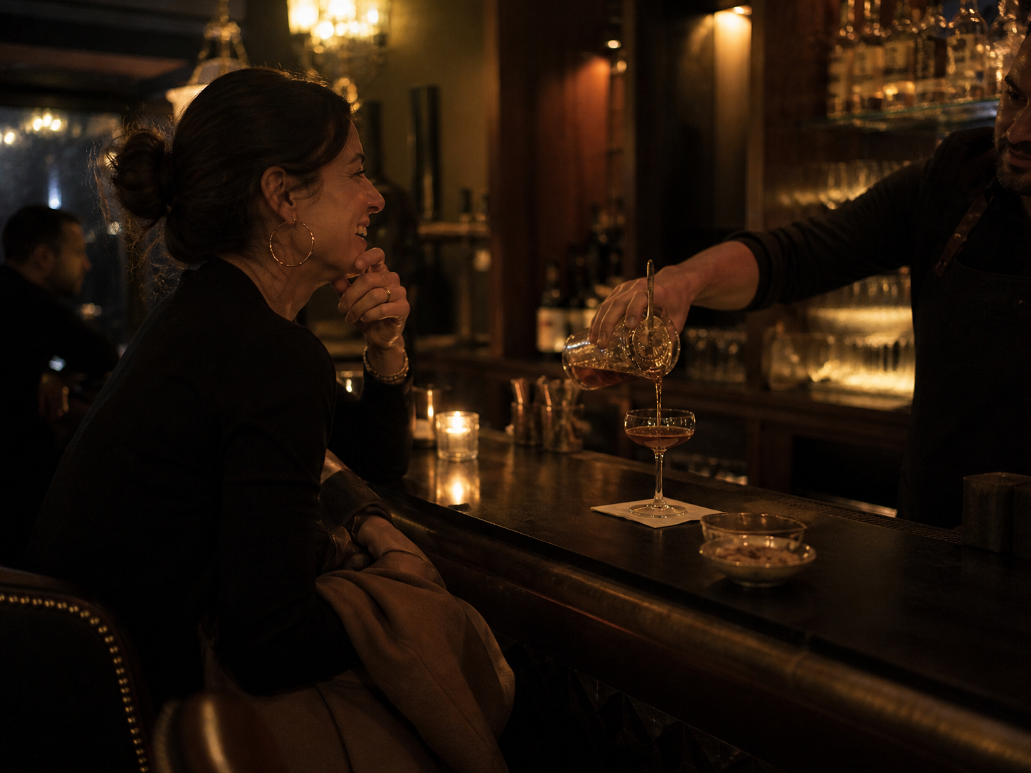 A returning regular at the bar, the bartender already pouring her usual without being asked